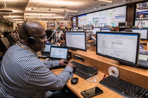 man-working-multiple-monitors man-working-multiple-monitors
