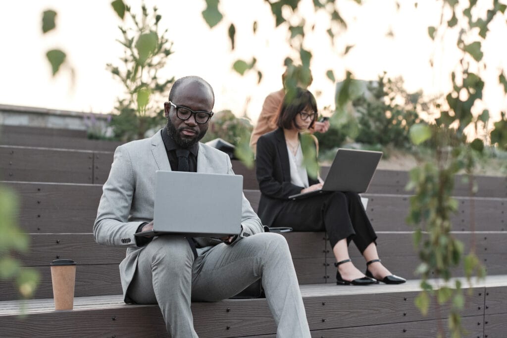 Business People Using Laptops Outdoors